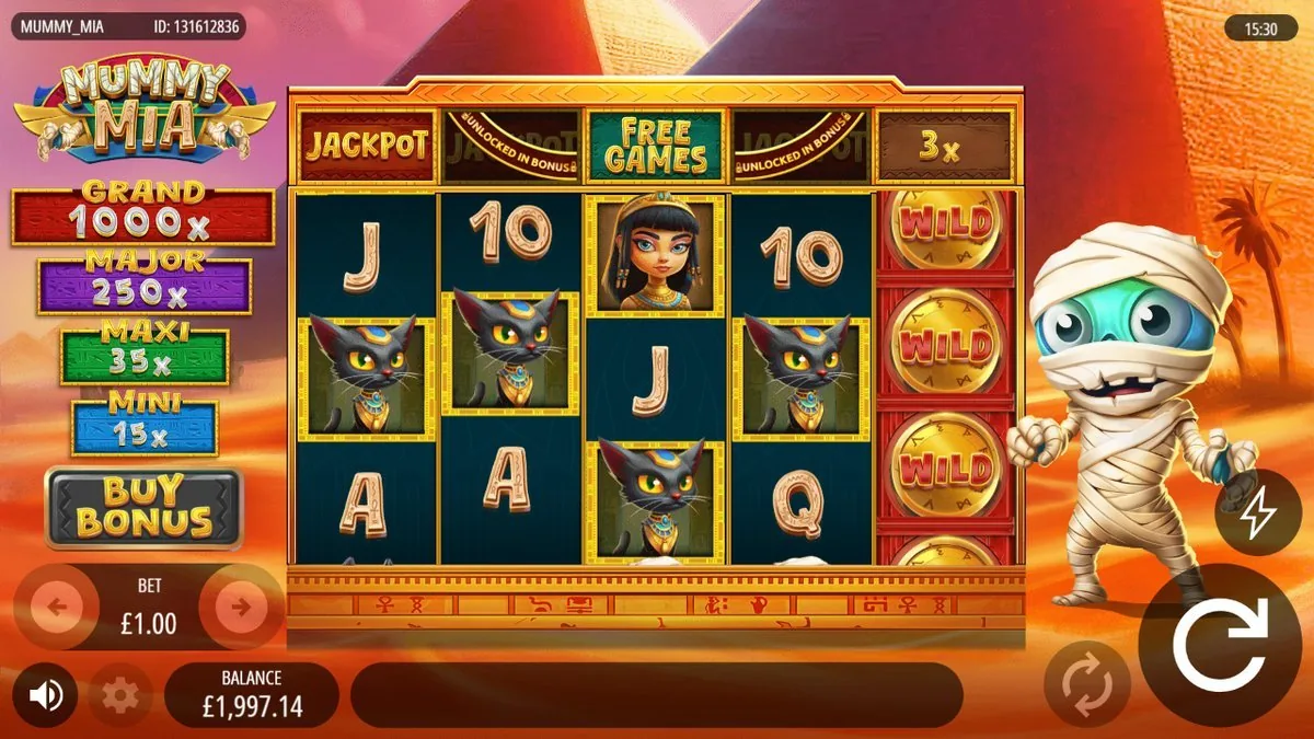 The base reels on a £1 bet — card royals, black cats and Cleopatra, with the whole fifth reel stacked wall-to-wall with gold WILD coins and the little mummy mascot bouncing on the right. The top bar shows FREE GAMES and the jackpot tiles marked ‘unlocked in bonus'.