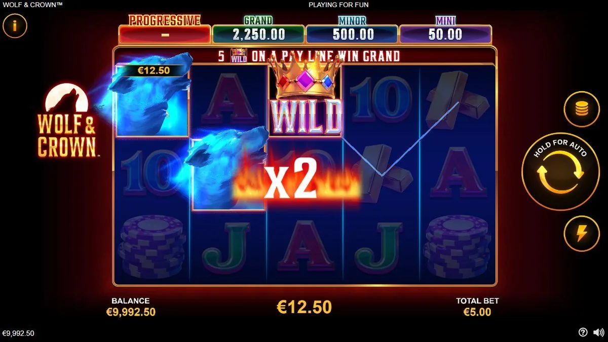 A blue wolf blazing across the reels with the fire-framed ×2 splash — the Crown wild doubling the line for a €12.50 win on the €5.00 spin. Balance ticking up to €9,992.50.